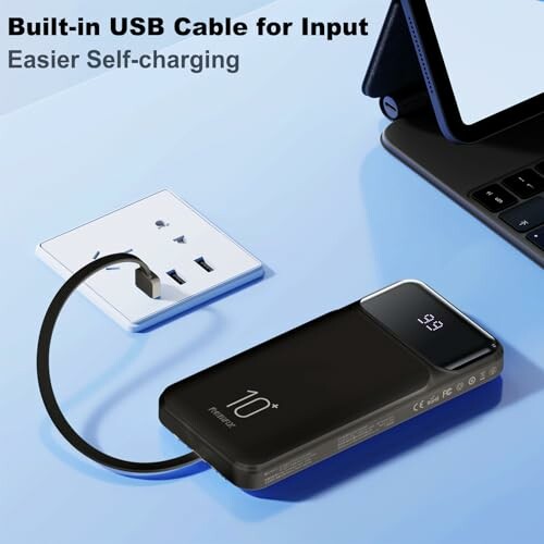 Power bank with built-in USB cable connected to a wall socket and charging a laptop.