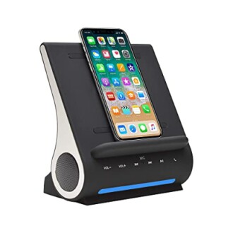 Smartphone on a speaker dock with control buttons.